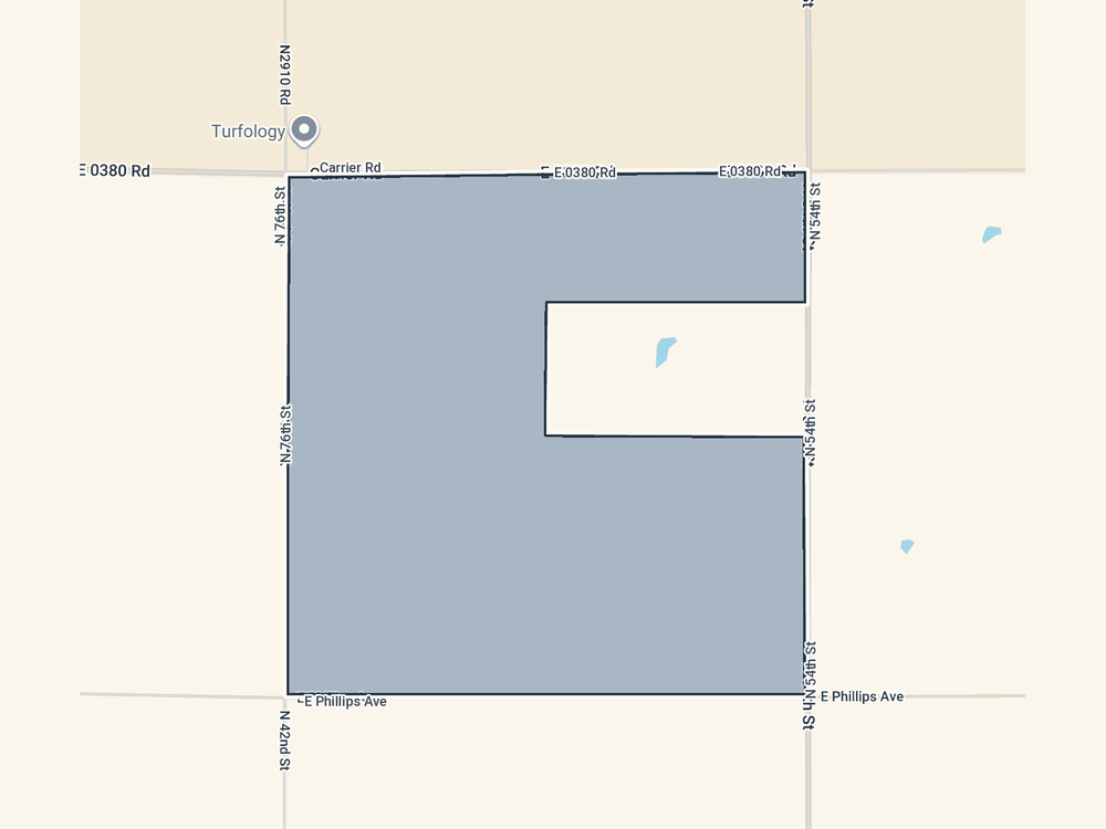 Parcel map of the proposed North campus, bounded by Carrier Road on the north, East Phillips Avenue on the south, North 42nd Street on the west and North 54th Street on the east, with one interior quarter excluded from the boundary.